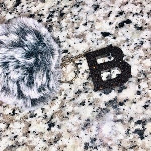 Initials and pom.